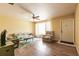 Bright living room with hardwood floors, ceiling fan, and neutral-colored furniture at 20409 Emerald Ave, Port Charlotte, FL 33952
