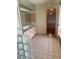 Bright bathroom featuring a double vanity, tile floors, and a connecting room through an open doorway at 214 Castile Ct, Punta Gorda, FL 33983