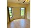 Bedroom featuring two large windows, neutral paint, and tile floors at 214 Castile Ct, Punta Gorda, FL 33983