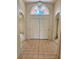 Bright foyer with tiled floor and arched window above double front doors, offering a welcoming entrance at 214 Castile Ct, Punta Gorda, FL 33983