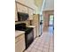 Functional kitchen featuring a black oven and microwave, and a tiled floor for easy maintenance at 214 Castile Ct, Punta Gorda, FL 33983