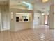 Spacious living area with tiled flooring, and an open bar area that connects to the kitchen at 214 Castile Ct, Punta Gorda, FL 33983