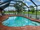 Sparkling enclosed pool with surrounding patio and views of the yard at 214 Castile Ct, Punta Gorda, FL 33983