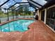 Enclosed pool area with a pool, outdoor furniture, and a well-maintained pool deck at 214 Castile Ct, Punta Gorda, FL 33983
