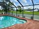 Relaxing screened-in pool area with outdoor seating and tranquil landscaping at 214 Castile Ct, Punta Gorda, FL 33983