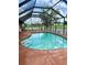 Enclosed pool featuring a patio area, surrounded by an enclosure and a well-maintained yard at 214 Castile Ct, Punta Gorda, FL 33983