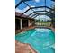 Enclosed pool with a beautiful sky reflection and an outdoor seating area at 214 Castile Ct, Punta Gorda, FL 33983