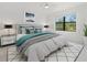 Stylishly furnished bedroom with a ceiling fan and a large window overlooking the lush landscape at 2161 Gardenia Ave, Port Charlotte, FL 33953