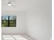 Light and airy bedroom with a ceiling fan and a window overlooking the garden at 2161 Gardenia Ave, Port Charlotte, FL 33953