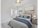 Well-lit bedroom features a ceiling fan, neutral walls, and en-suite bathroom at 2161 Gardenia Ave, Port Charlotte, FL 33953