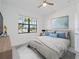 Comfortable bedroom featuring a ceiling fan, natural light, and a serene ambiance at 2161 Gardenia Ave, Port Charlotte, FL 33953