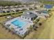 Aerial view of community pool with cabana, lounge chairs, tennis and playground area at 2161 Gardenia Ave, Port Charlotte, FL 33953