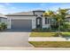 Charming single-story home featuring a paved driveway, two-car garage, and manicured landscaping at 2161 Gardenia Ave, Port Charlotte, FL 33953