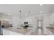 Modern kitchen showcases white cabinets, granite countertops, a center island, and stainless steel appliances at 2161 Gardenia Ave, Port Charlotte, FL 33953
