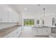 Spacious kitchen featuring white cabinets, granite countertops, and an open layout to backyard at 2161 Gardenia Ave, Port Charlotte, FL 33953