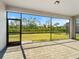 Relax on the screened patio overlooking the lush green backyard with beautiful views of the surrounding landscape at 2161 Gardenia Ave, Port Charlotte, FL 33953