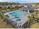 Community pool with ample seating, shady pavilions, and well-manicured landscaping at 2161 Gardenia Ave, Port Charlotte, FL 33953