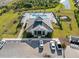 Aerial view of community pool, clubhouse, lounge chairs, and lush tropical landscaping at 2161 Gardenia Ave, Port Charlotte, FL 33953