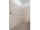 Neutral tiled walk-in shower with brown flooring and sleek fixtures in a modern style bathroom at 2161 Gardenia Ave, Port Charlotte, FL 33953