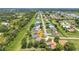 Community aerial view showcasing houses on a long street, pond, and lots of land at 2210 Mauritania Rd, Punta Gorda, FL 33983
