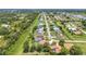 Community aerial view showcasing houses on a long street, pond, and lots of land at 2210 Mauritania Rd, Punta Gorda, FL 33983