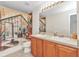 Bathroom with double sink vanity, decorative shower curtain, and neutral color scheme at 2210 Mauritania Rd, Punta Gorda, FL 33983