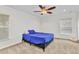 Bright bedroom featuring a ceiling fan, carpet floors, and a comfortable bed at 2210 Mauritania Rd, Punta Gorda, FL 33983