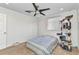 Carpeted bedroom with a ceiling fan, natural light, and a pet play area at 2210 Mauritania Rd, Punta Gorda, FL 33983
