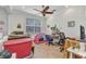 Bright bedroom featuring neutral walls, ceiling fan, and space used for work, play, and storage at 2210 Mauritania Rd, Punta Gorda, FL 33983