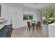 Dining area with modern lighting fixture, window views, and sliding glass door to outdoor patio at 2210 Mauritania Rd, Punta Gorda, FL 33983