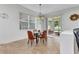 Dining area with contemporary lighting, window with a view, and access to the screened patio at 2210 Mauritania Rd, Punta Gorda, FL 33983