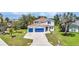Two-story home boasting a 2-car garage, manicured lawn, and tasteful landscaping at 2210 Mauritania Rd, Punta Gorda, FL 33983
