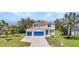 Two-story home boasting a 2-car garage, manicured lawn, and tasteful landscaping at 2210 Mauritania Rd, Punta Gorda, FL 33983