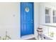 Welcoming bright blue front door with a decorative wreath and charming curb appeal at 2210 Mauritania Rd, Punta Gorda, FL 33983