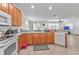 Traditional kitchen with wooden cabinets, white appliances, tile flooring, and natural light at 2210 Mauritania Rd, Punta Gorda, FL 33983