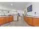 Bright kitchen featuring wooden cabinets, tile flooring, a dishwasher, and an open layout at 2210 Mauritania Rd, Punta Gorda, FL 33983