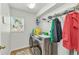 Bright laundry room with front loading washer and dryer and ample shelving for organization at 2210 Mauritania Rd, Punta Gorda, FL 33983