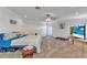 Main bedroom featuring bright lighting, a ceiling fan, carpet floors, and a TV at 2210 Mauritania Rd, Punta Gorda, FL 33983