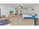 Large main bedroom featuring carpet floors, a ceiling fan, and an ensuite bathroom at 2210 Mauritania Rd, Punta Gorda, FL 33983