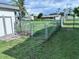Spacious backyard with a partial fence, shed, and lush green grass at 22187 Lasalle Rd, Port Charlotte, FL 33952