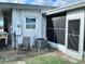 Exterior view of the backyard featuring a lawn chair and screened in porch at 22187 Lasalle Rd, Port Charlotte, FL 33952