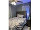 Cozy bedroom with overhead lighting, curtains, nightstand, and decor at 22187 Lasalle Rd, Port Charlotte, FL 33952