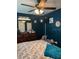 A primary bedroom with a ceiling fan, dresser, and cushioned bench by the window at 22187 Lasalle Rd, Port Charlotte, FL 33952