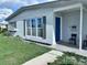 Charming single-story home with a vibrant blue front door and covered entrance at 22187 Lasalle Rd, Port Charlotte, FL 33952