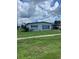 Well-maintained, single-story home with tidy front lawn and car port at 22187 Lasalle Rd, Port Charlotte, FL 33952