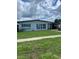Well-maintained, single-story home with tidy front lawn and car port at 22187 Lasalle Rd, Port Charlotte, FL 33952