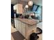 Kitchen with a white kitchen island, white cabinets, stainless steel appliances, and granite countertops at 22187 Lasalle Rd, Port Charlotte, FL 33952