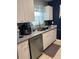Bright kitchen featuring stainless steel appliances, granite countertops, and white cabinets at 22187 Lasalle Rd, Port Charlotte, FL 33952