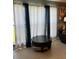 View of a living room featuring a large round coffee table and patterned curtains at 22187 Lasalle Rd, Port Charlotte, FL 33952