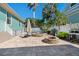 Backyard showcasing a stone firepit, covered outdoor seating, mature palms, and charming outdoor design at 233 Durrance St, Punta Gorda, FL 33950